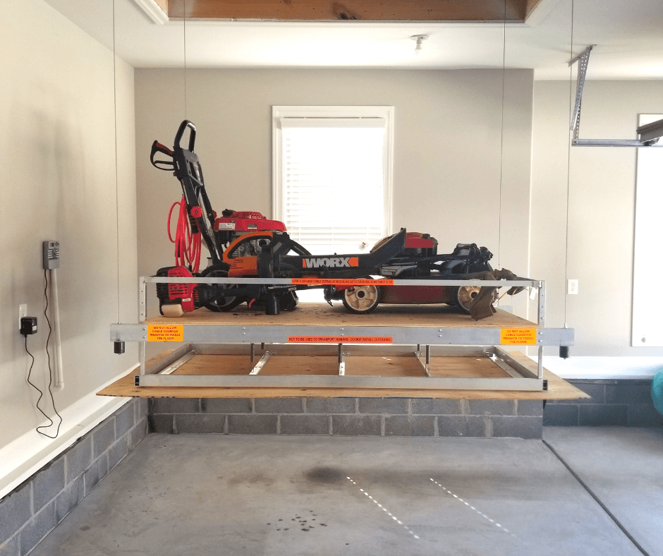 Lawn equipment on attic lift Lawn equipment on attic lift
